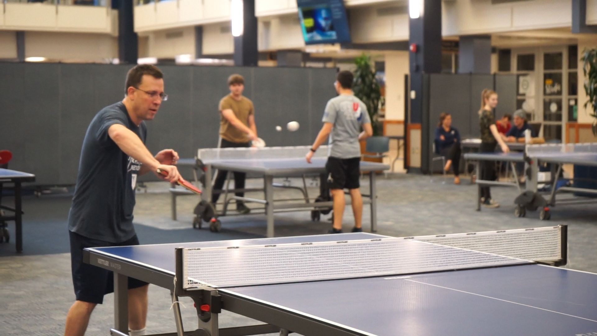 John Colton playing ping pong.